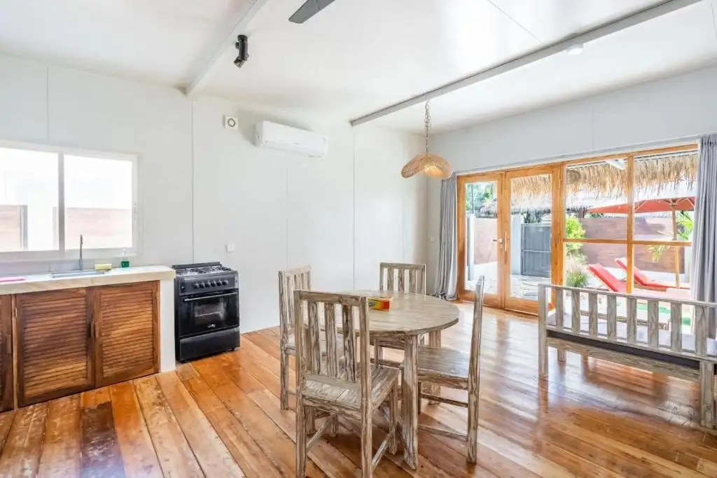 Kitchen with gas stove and teak dining table