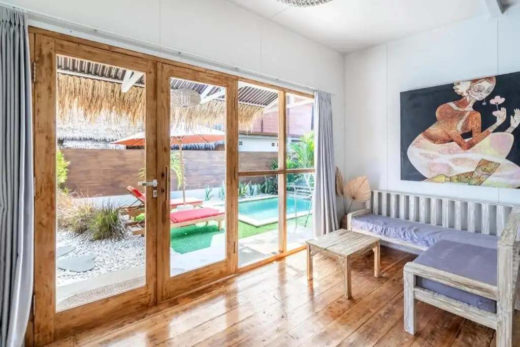 Living room with glass doors opening to the pool