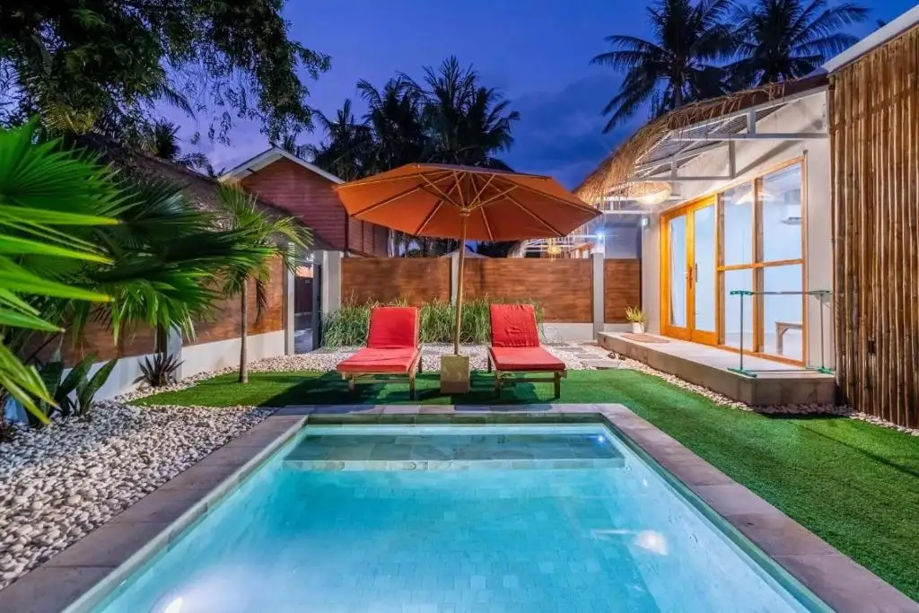 Villa and lit pool at dusk
